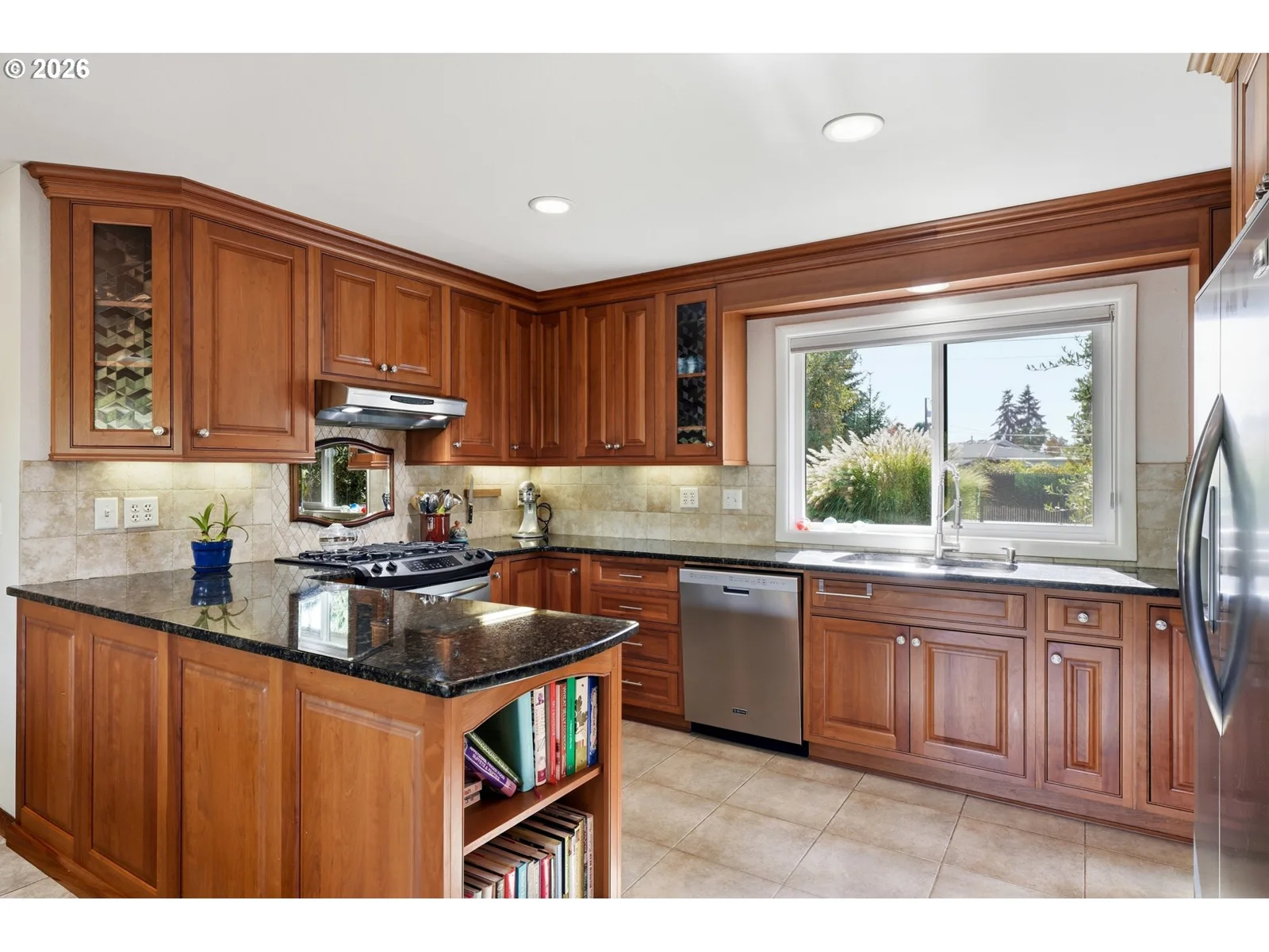 Kitchen with wood cabinetry and granite counters